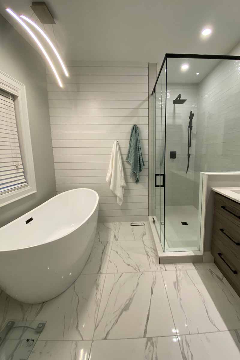 Renovated bathroom with stylish tub glass shower